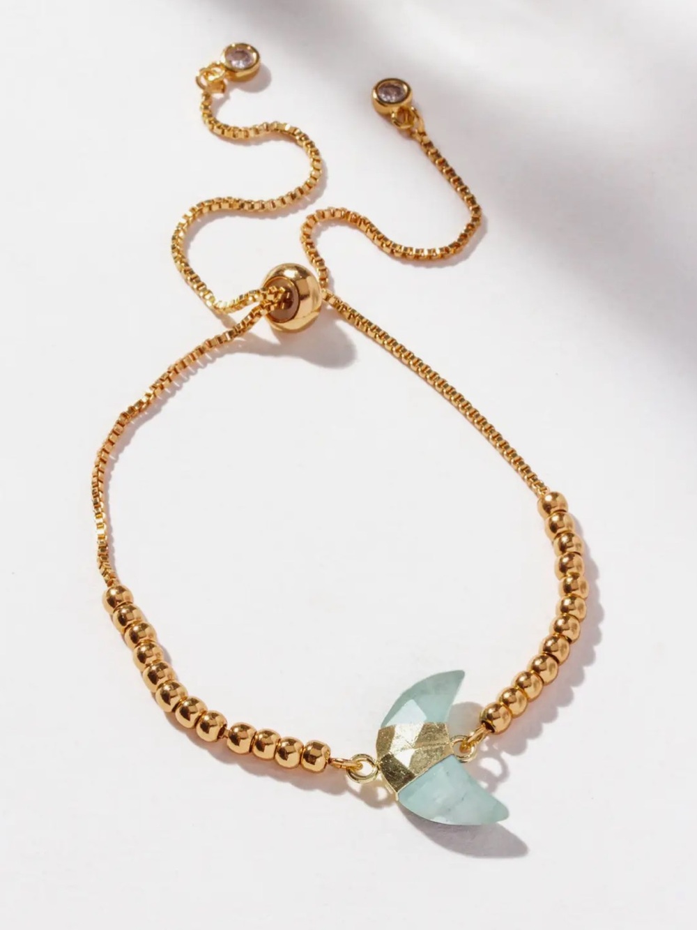 A464. Luna Norte Adjustable Gold Beaded Bracelet with Aqua Crescent Stone